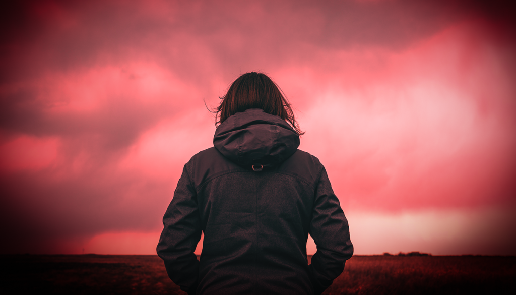 woman looking at red sky