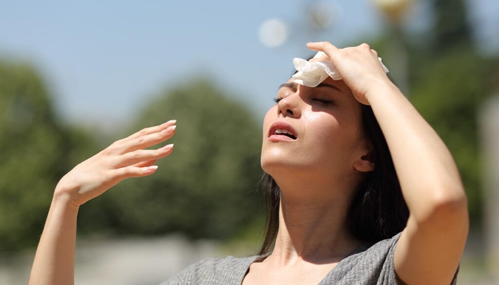 Woman suffering from extreme heat