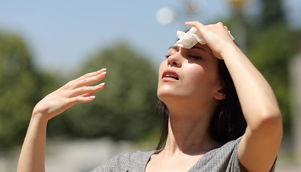 Woman swooning in the heat