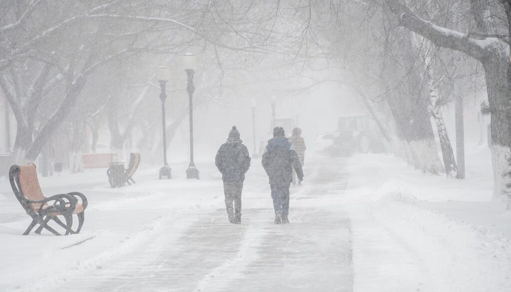people walking in a snowstorm