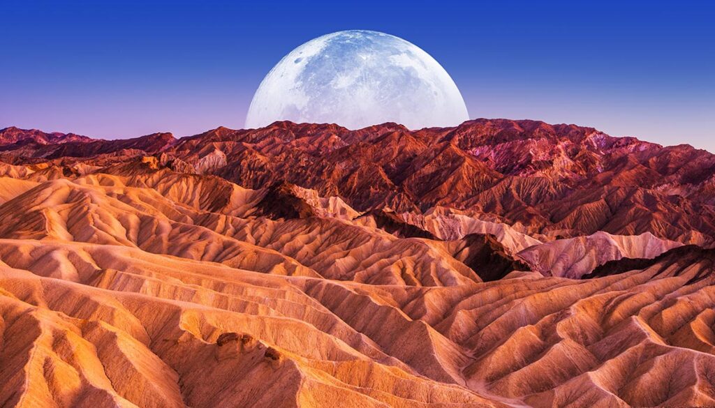 Death Valley Scenic Night. Death Valley National Park Badlands Sandstones Landscape and the Moon. California, United States.